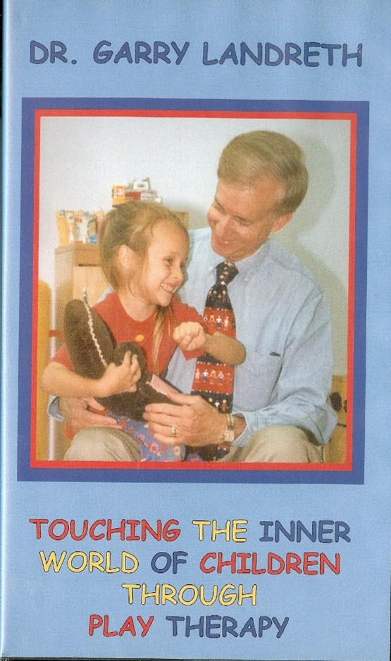 A man sitting with a small child who is laughing.